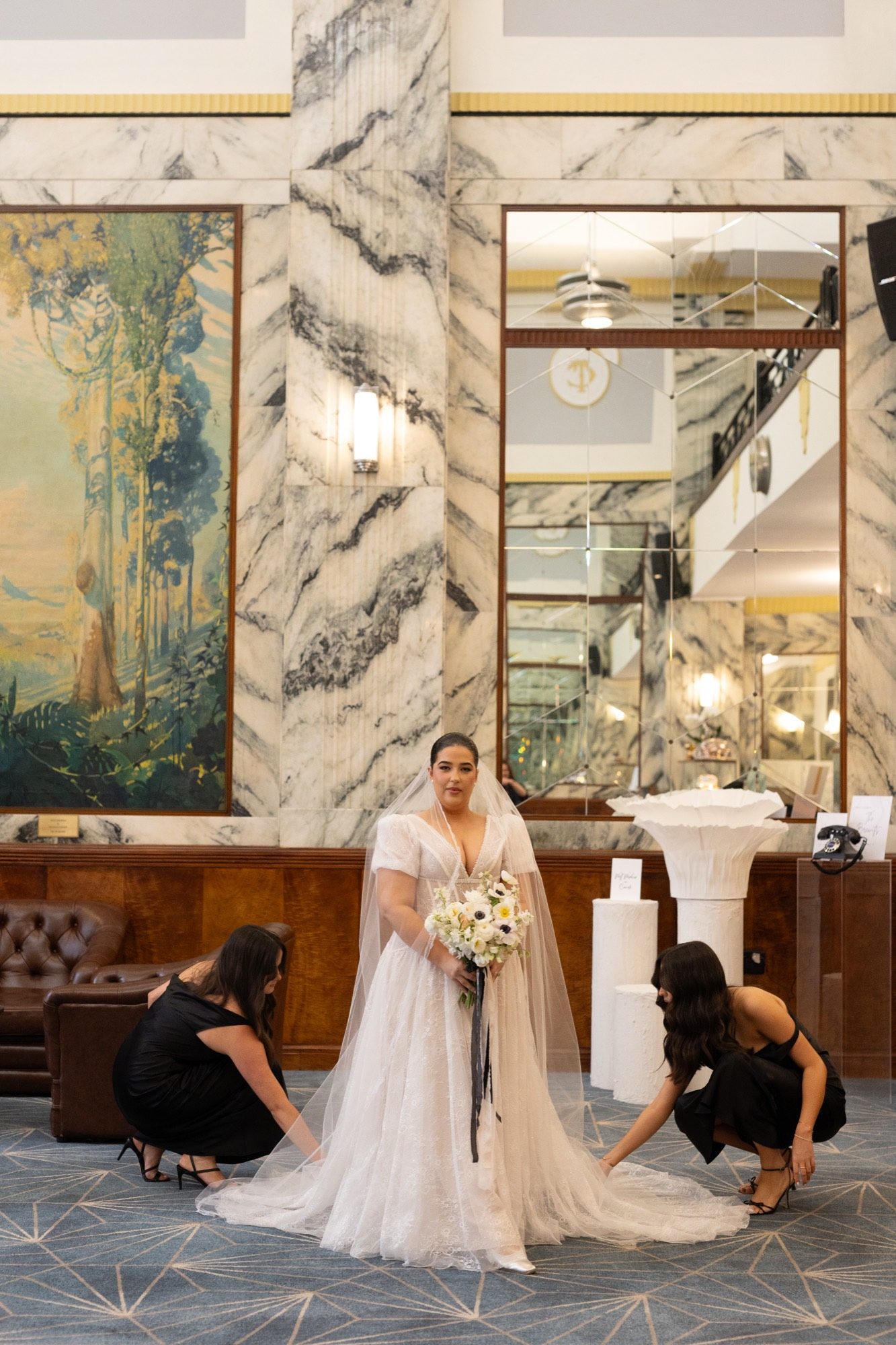 Bridesmaids arranging the bride's lace train and veil, Tattersall's Club Brisbane