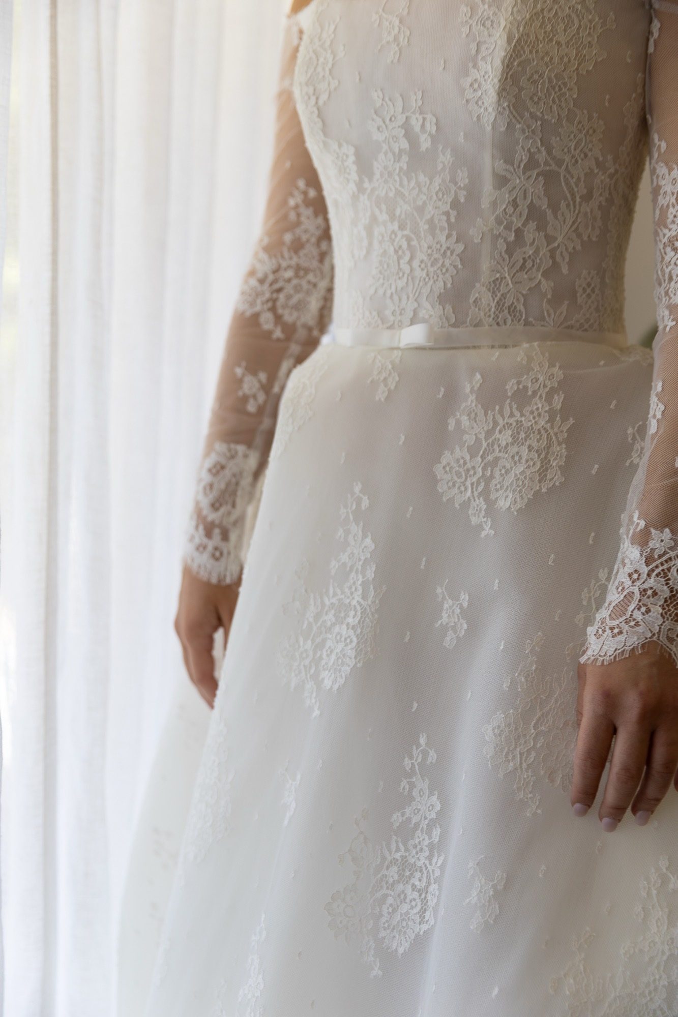 Detail of the lace bodice and full tulle skirt in window light, Freedom Shores, Airlie Beach